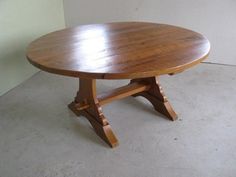 a wooden table with apples on it in the middle of an empty room and sunlight coming through the window