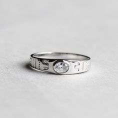 >Oval cubic zirconia bezel set on sterling silver band . >Sterling silver is an almost pure metal made from 92.5% Silver. >Approx. 4mm band width face and 2.5mm back >cubic zirconia; 3.5mm x 5mm FREE SHIPPING USA- All of our jewelry will arrive in custom packaging ready for gift giving. CARE: To prolong the color and shine of your jewelry, avoid contact with perfume, lotion, and water. Store in a bag or jewelry box. SATISFACTION GUARANTEED All pieces are carefully examined prior to d Silver Cubic Zirconia Diamond Ring With Birthstone, Silver Diamond Ring With Birthstone In Cubic Zirconia, Silver-toned Cubic Zirconia Ring With Birthstone, Classic Cubic Zirconia Initial Promise Ring, Silver Oval Stackable Promise Rings, Sterling Silver Solitaire Signet Ring For Promise, Silver Signet Ring With Cubic Zirconia Round Cut, Sterling Silver Initial Promise Ring, Sterling Silver Initial Ring With Round Cut