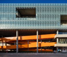 an orange and blue building with columns in front