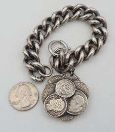 a coin and chain on a white surface