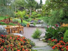 an outdoor garden with flowers and trees