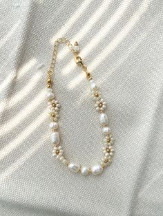 The ALMA beaded bracelet is dainty and elegant. Featuring freshwater pearls and white pearl color seed beads, this is the perfect gift for a bride, friend, sister, daughter, etc. 100% handmade using the best materials.  FEATURES:  * Seed beads sizes 3 to 4mm, freshwater pearls 5-7mm * 18k Gold Plated Lobster clasp and extender chain * Made with love and care. LENGHT: Choose between 6.5 or 7 inches + Each bracelet comes with a 1 inch extender chain CARE INSTRUCTIONS: *Remove before exercising tak Elegant Pearl Beaded Bracelets With Tiny Beads, Elegant Pearl Beaded Bracelet With Tiny Beads, Elegant Pearl Bracelet With Tiny Beads, Elegant Tiny Beads Pearl Bracelet, Tiny Beads Pearl Bracelet, Pearl Bracelet With Tiny Beads As Gift, Gift Pearl Bracelet With Tiny Beads, Dainty Pearl Beaded Bracelets With Round Beads, Pearl Bracelets With Tiny Beads For Wedding