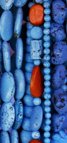 blue and orange beads are stacked on top of each other, with one red bead in the middle