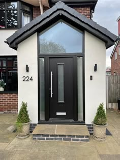 a black and white house with the number 22 on it's front door is shown