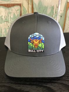 Bull City Stained Glass Patch Durham NC Trucker Hat AG Outfitters Exclusive Design, share our love of Durham, NC! Captuer brand hat, custom division of Richardson Caps Carolina Dog, Durham Nc, Flag Patches, Leather Patches, Durham, Exclusive Designs, Charcoal Grey, Division, Clothing Items