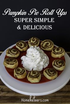 pumpkin pie roll ups on a red plate with whipped cream and cinnamon rolls in the middle