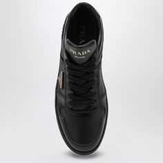 Black leather low top trainer from Prada featuring round toe, perforated upper, lace-up fastening, contrasting lettering logo print on tongue, enamelled metal logo triangle detail on side, leather heel with contrasting lettering logo and rubber sole. Size Type: ITMaterial: LeatherSKU: 1E792MDD303LPH/P_PRADA-F0002_500 Our Products Are 100% Genuine. In All Cases We Stand By The Authenticity Of Every Product Sold On Our Site. Black High-top Sneakers With Logo Detail, Black Sporty Sneakers With Logo Detail, Sporty Black High-top Sneakers With Logo Detail, Sporty Black High-top Sneakers With Logo, Classic Black High-top Sneakers With Perforations, Luxury Black Sneakers With Embossed Logo, Black Leather High-top Sneakers With Perforations, Classic Black Sneakers With Perforations, Black High-top Lace-up Sneakers With Perforated Toe Box