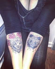 two people with tattoos on their legs sitting next to each other