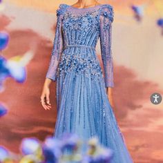 Step Into A Fairy Tale With The Exquisite Azurite Embellished Gown. This Gorgeous Gown Features Intricate Beading And Delicate Embellishments That Give It A Whimsical, Romantic Touch. The Stunning Layered Glitter Tulle Creates An Ethereal Effect That Will Make You Feel Like A Real-Life Queen. Its Belted Waistline Adds Structure To This Magical Dress, Perfect For Any Dreamy Or Enchanted Occasion. Bring Your Fairy Tale To Life In This Long Sleeve Beauty. ***Please Make Sure To Measure Yourself Bef Blue Floral Embellished Evening Gown, Blue Floral Embellished Gown For Gala, Blue Floral Embellished Floor-length Evening Dress, Blue Floral Embellished Evening Dress For Gala, Blue Embellished Dress For Gala, Blue Hand Embellished Gown For Formal Occasions, Blue Hand Embellished Formal Gown, Formal Blue Hand Embellished Gown, Glamorous Blue Embellished Gown