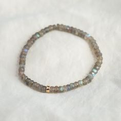 Want to save 15% off your first order? Sign up for our newsletter by visiting our website and filling out the pop up form. Receive a code by email, then send us that code through Etsy messages to save 15% off your ETSY order, sign up here: www.earthlyabundancejewelry.com  Super flashy beautiful labradorite, available two options: #1 Stretch bracelet - on elastic with a 14K gold filled accent  D E T A I L S △ Handmade in Canada △ Genuine Labradorite 4-4.5mm (roughly) △ 14K gold filled clasp and e Minimalist Rondelle Gemstone Beaded Bracelets, Minimalist Hand-strung Rondelle Beaded Bracelets, Moonstone Beaded Bracelets With Natural Stones, Dainty Rondelle Beaded Bracelets For Everyday, Minimalist Natural Stone Beaded Bracelets For Everyday, Everyday Jewelry With Gemstone Beads And Labradorite, Minimalist Rondelle Gemstone Beads Bracelets, Everyday Jewelry With Labradorite Gemstone Beads, Everyday Labradorite Jewelry With Gemstone Beads