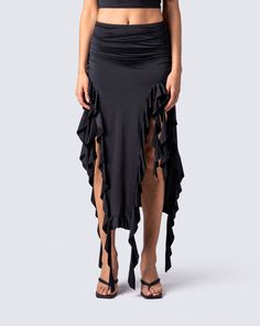 Owning an entire room has never been easier 😏 Rock your darker side with this sultry black jersey skirt. Complete with a high-waisted fit, shirring at the waist and hips, and front cutout detailing with a cascading ruffle hem 🖤 Black Ruched Bottoms For Evening, Summer Party Maxi Skirt In Elastane, Chic Black Draped Skirt With Ruched Detail, Chic Black Ruched Draped Skirt, Black Ruched Draped Skirt For Evening, Black Ruched Maxi Skirt For Summer, Flowy Ruched Maxi Skirt For Night Out, Black Ruched Long Skirt, Ruched Skirt Bottoms For Evening