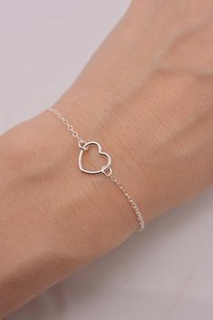 REAL STERLING SILVER - A QUALITY PIECE This is an original design by The Violet Goat. I make this beautiful bracelet using a sterling silver heart charm set on sturdy sterling silver chain (all 925 sterling). Secures with a lobster clasp and comes in a gift box. These make great group gifts. Heart measures approximately 1/2 inch. FEATURED ON WOMAN'S DAY WEBSITE: This little beauty had the honor of being featured on several different sites, including a gift guide article for Woman's Day. This ori Sterling Silver Double Heart Bracelet, Mother's Day Sterling Silver Heart Bracelet Gift, Adjustable Sterling Silver Bracelet For Valentine's Gift, Sterling Silver Double Heart Bracelet Gift, Minimalist Sterling Silver Heart Bracelet For Mother's Day, Minimalist Silver Heart Bracelet For Anniversary, Sterling Silver Double Heart Bracelets, Adjustable Delicate Sterling Silver Heart Bracelet, Sterling Silver Open Heart Bracelet For Mother's Day