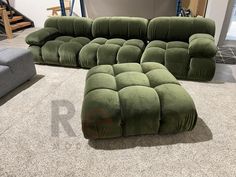 a green couch and ottoman in a room