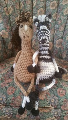 two crocheted stuffed animals sitting on a couch