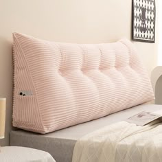 a bed with a pink pillow on top of it