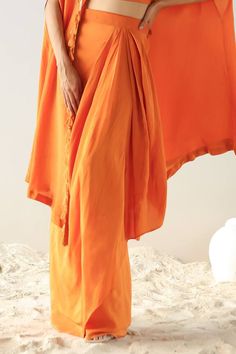 Orange long cape with all over placement floral pattern, multi color thread, sequin and zari hand embroidery. Paired with pleated draped skirt and floral embroidered blouse. - Aza Fashions Traditional Dresses With Draped Sleeves, Silk Palazzo Set With Traditional Drape, Festive Draped Silk Sets, Designer Saree Dress With Draped Sleeves, Traditional Silk Palazzo Set With Cape Sleeves, Festive Silk Sets With Draped Sleeves, Silk Floor-length Sets With Draped Sleeves, Silk Sets With Draped Sleeves, Silk Sets With Draped Sleeves In Traditional Drape