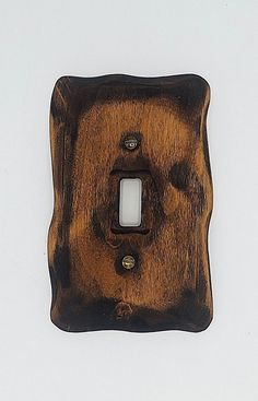 a single light switch cover in wood