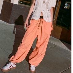 Urban Outfitters Nylon Jogger Pant. New With Tags, Orange, Size Small, Medium And Xl. Lightweight Nylon Jogger Pant From Urban Outfitters. Pull-On Design Offers A Slouchy Fit With Elastic Banding At The Tie-Waist And Cuffs. Topped With Utility Pockets At The Leg And Slip Pockets At The Hips. Content + Care - 100% Nylon - Machine Wash Size + Fit - Model In Orange Is 5’10” And Wearing Size Small - Rise: 14.25” - Inseam: 26” - Leg Opening: 14” Wide Leg Parachute Pants For Summer Outdoor Activities, Summer Wide Leg Parachute Pants For Outdoor, Summer Outdoor Wide Leg Parachute Pants, Sporty Parachute Pants For Summer Outdoor, Sporty Summer Parachute Pants For Outdoor, Loosely Fitted Cargo Parachute Pants For Spring, Trendy Stretch Parachute Pants For Summer, Solid Parachute Pants For Summer Outdoor, Sporty Summer Cargo Pants With Drawstring