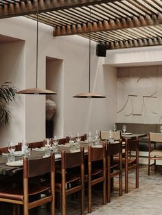 an empty restaurant with wooden tables and chairs