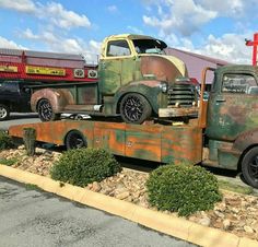 an old truck is parked in the parking lot