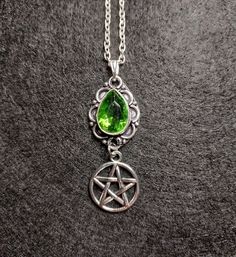 Pentacle Peridot Necklace  SIZE 4.5x1.7cm / 1.5x0.5 inches  18 inch silver plated chain included Peridot Happiness, abundance and light.  Protection against difficulties and negativity. We try and describe and take all photos to truly show what the item is like in real life, but due to different devices, screens, cameras and brightness levels there may be some slight variations. Measurements are approximate. Gothic Dangle Necklaces As Gifts, Mystical Handmade Green Jewelry, Mystical Green Gemstone Jewelry, Gothic Dangle Necklaces For Gifts, Gothic Dangle Necklace For Gift, Green Handmade Mystical Jewelry, Handmade Mystical Green Jewelry, Handmade Green Mystical Jewelry, Spiritual Green Round Pendant Crystal Necklace