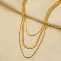 Elevate your style with our Three Strand Gold or Silver Plated Snake Chain Necklace! Featuring a sleek and modern design, this necklace adds a touch of elegance to any outfit. The three strands offer a unique and eye-catching look, while the gold or silver plating adds a luxurious touch. Upgrade your wardrobe with this stunning piece today! Details: - Outer Length 50 + 5cm - Inner Length 42cm - Imported - 18K Gold Plated, Silver Plated Trendy Gold Long Layered Necklace, Trendy Gold Multi-strand Necklace, Trendy Gold Snake Chain Layered Necklace, Nickel-free Gold Snake Chain Jewelry, Silver Gold-plated Snake Chain Necklace, Minimalist Multi-strand Gold Layered Necklace, Minimalist Gold Multi-strand Layered Necklace, Silver Brass Snake Chain Necklaces, Adjustable Gold-plated Snake Chain Necklace