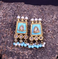 This Earrings is crafted using traditional techniques in 22k Yellow Gold with turquoise pearls and Polki Diamonds. The Turquoise are all natural and have a rough organic look, thus enhancing the rawness and beauty of the piece. Turquoise also known as Firoza has remarkable healing properties and ensure overall physical fitness. It enhances immunity and eliminates pollution inflicted diseases. The Birthstone for December, Turquoise is said to bring good luck, peace and protection. Turquoise is also the 11th wedding anniversary gemstone. Gross Weight: 12.930 gms Dimensions: Length: 36mm Width: 16mm Perfect for any look or occasion!  Packaging and Shipping Your item is packed very carefully to avoid any in-transit damage. We first pack it in a zip pouch and then put it in a Bubble Pouch. Your Elegant Turquoise Kundan Earrings, Elegant Turquoise Meenakari Earrings, Traditional Turquoise Earrings For Wedding, Elegant Turquoise Earrings For Festivals, Elegant Turquoise Earrings For Festive Season, Elegant Turquoise Earrings For Festive Occasions, Turquoise Kundan Earrings For Festivals, Turquoise Meenakari Temple Jewelry Earrings, Traditional Turquoise Danglers For Wedding