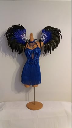 a mannequin with black and blue feathers on it