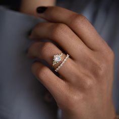 a woman's hand with two rings on it