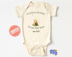 A little Hunny Is On The Way Pooh Custom Baby Onesie® ✤ GARMENT OPTIONS ✤ ❤️ Baby Bodysuit ❤️ We use Cotton Gerber Onesies®: --Gerber® Onesies®-- . 100% cotton rib. . Machine wash & dry. . Expandable lap shoulder neckline. . Comfortable ribbed leg opening. . Higher in-the-front bottom snap closure.  Gerber products tend to run small, so we recommend sizing up if you are close to the next size. For more information on sizing, please see listing photos  ❤️ Toddler Shirt ❤️ Gerber and Bella Canvas  Toddler Shirt: . Topstitched ribbed collar. . Shoulder-to-shoulder self-fabric back neck tape. . Double needle sleeves and bottom hem. . CPSIA compliant tracking label on side seam. . EasyTear™ label. ❤️ Youth Shirt ❤️ Bella Canvas Youth Shirt: .4.2 oz./yd² (US) 7 oz./L yd (CA), 100% airlume combed Custom Baby Onesies, Youth Shirt, Pooh Bear, Front Bottoms, Natural Baby, Hope Chest, Custom Baby, Gender Neutral Baby