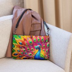 🦚Keep your style on point and your hands free with our Versatile Crossbody/Shoulder Bag Purse with a Unique & Colorful Peacock Design. It's made of premium faux leather and features dark gray hardware. Thanks to the zip-top closure and multiple inside pockets, you can keep your essentials secure and organized. Transform this crossbody bag with removable wrist and shoulder straps to style it for day-to-night looks. * Outer fabric: faux leather  * Lining: 100% polyester * 11″ × 8″ × 1.5″ (27.9 cm × 20.3 cm × 3.8 cm) * Dark gray hardware * Zip-top closure * Inside zip and slip pockets * Adjustable, removable wrist and shoulder straps * Strap drop length: 14″- 27″ Our Other Crossbody Bags: https://www.etsy.com/shop/ZazzFashion?section_id=45645921 Trendy Multicolor Phone Bag For Daily Use, Multicolor Satchel Shoulder Bag With Mobile Phone Pocket, Multicolor Pouch Shoulder Bag For Mobile Phone, Multicolor Clutch Mobile Phone Bag, Multicolor Clutch With Mobile Phone Bag, Multicolor Mobile Phone Pouch Shoulder Bag, Multicolor Handheld Shoulder Bag, Multicolor Mobile Phone Pouch Bag, Trendy Multicolor Mobile Phone Bag