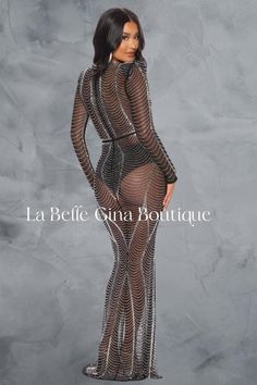 a woman wearing a sheer mesh bodysuit with long sleeves and thigh high slits