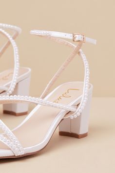 From cute date nights to wedding invites, step out with confidence in the Lulus Makenna White Pearl Satin Strappy Ankle Strap Low Heel Sandals! These wear-with-anything sandals have a sleek woven satin construction that shapes a trendy square footbed with a slender toe strap and crisscrossing vamp straps. An adjustable ankle strap sprouts from the sides and secures with a shiny gold buckle, all atop a cute block heel. Gleaming faux pearl details throughout lend an extra fabulous finish. 2. 5" wrapped block heel. Light cushioned insole. Felted rubber sole has nonskid markings. Man made materials. Imported. Lulus | Makenna White Pearl Satin Strappy Ankle Strap Low Heel Sandal Heels | Size 8.5. Short Heel Bridal Shoes, White Homecoming Shoes, Small Heel Bridal Shoes, White Heels Bridesmaid, Hoco Heels White, Sweet Sixteen Shoes, Small Wedding Heels, Wedding Short Heels, Homecoming Shoes Low