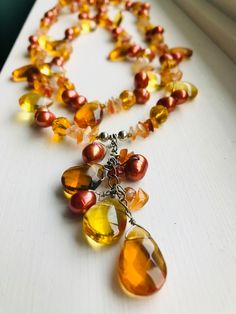 "This one of a kind necklace features a double strand of rich bronze freshwater pearls, agate, carnelian and deep honey coloured glass and crystal beads with a silver floral rhinestone clasp. The shorter strand is 17\"\" in length , the longer strand is 19\" in length and the front drop pendant portion is just over 2\" in length. Gift boxed! Also visit my other Etsy shop for simple fabulous vintage finds. www.etsy.com/shop/BjeweledJustVintage" Luxury Amber Beaded Necklaces With Large Beads, Elegant Orange Necklaces With Natural Stones, Multi-strand Pearl Necklace With Natural Stones For Gifts, Gift Multi-strand Pearl Necklace With Natural Stones, Double Strand Gold Pearl Necklace With Gemstone Beads, Gold Double Strand Pearl Necklace With Gemstone Beads, Double Strand Jewelry With Unique Variations As Gift, Elegant Beaded Citrine Jewelry, Elegant Multi-strand Crystal Necklace For Gift