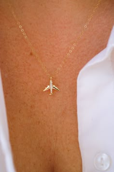 Let your wanderlust take flight with our new Airplane Necklace! This beautiful necklace features a stunning 18K gold-plated brass airplane charm adorned with sparkling cubic zirconia accents. Crafted with attention to detail, all necklace findings are made of 100% gold-filled materials to ensure the highest quality piece! Perfect for travel enthusiasts or anyone who loves to add a touch of adventure to their outfit, our Airplane Necklace is a beautiful and unique piece of jewelry! NECKLACE FEATU Beautiful Gold Necklaces Unique, Necklace Airplane, Plane Jewelry, Aviation Jewelry, Airplane Jewelry, Plane Necklace, Best Necklace, Airplane Necklace, Travel Inspired Jewelry