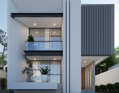 an apartment building with two balconies and plants on the balcony area in front of it