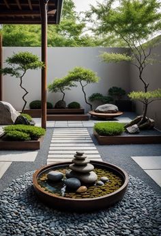 a garden with rocks and trees in the center, surrounded by graveled walkways