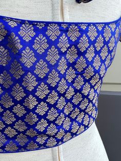 Brocade Royal Blue Color Readymade Blouse in Size 36 with padding. A dori or tie is added at the back of the blouse. Blouse has margin to open to size- 40 Item : BlouseSize : 36Color : Royal Blue Blouse Fabric : Brocade SilkBlouse Fitting : Princess Cut Lining : Yes, it is fully lined Padded or Non-Padded : Padded Closure: Front Closure with hooks.Ready-to-Wear : Yes Disclaimer - :-This is a Standard Size blouse. We do not guarantee perfect fit as every body and shape is different. Little or no Blouses For Sarees, Royal Blue Blouse, Brocade Blouse, Brocade Blouses, Readymade Blouse, Royal Blue Color, Blouse Fabric, Blue Blouse, Princess Cut