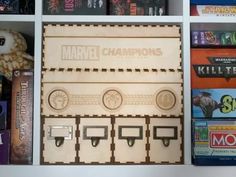 a wooden board game set sitting on top of a book shelf next to other games