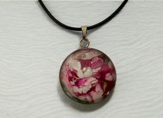 Why not treat yourself or a friend to this one-of-a-kind, wearable art, magenta, pink, white floral abstract pendant necklace. The design looks like a flower garden.  Perfect gift for Valentine's Day, birthdays, Mother's Day, anniversary, bridesmaid's gifts, teacher appreciation gift, BFFs, Bat Mitzvah or "just because".  Materials The pendant's design is made from acrylic pour paint and comes with a high-quality 24 inch black cotton waxed cord necklace with a metal clasp and extension chain (nickel-free).  The necklace comes with a sheer organza mesh jewelry bag with drawstring for gift giving and safe keeping. The round transparent glass cabochon is backed by a lightweight stainless steel tray and measures 25mm / 1 inch in diameter.  Photos were taken with a cell phone. The colors that y Artsy White Jewelry For Gifts, Artistic Flower-shaped Jewelry For Crafting, Artistic Pink Flower Jewelry, Artistic White Necklace For Gift, Artistic White Round Necklace, Artsy Purple Jewelry For Gifts, Pink Adjustable Flower Pendant Necklace, Adjustable White Hand Painted Necklaces, Adjustable White Hand Painted Necklace