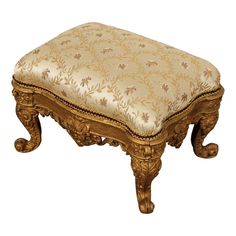 an ornate wooden bench with a gold upholstered cushion on the bottom and sides