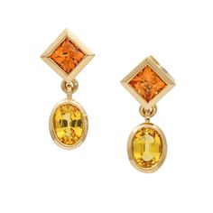 These Women's Madeira Citrine Yellow Sapphire Dangle Earrings In 18k Gold Are Stunning And Elegant. Each Earring Features Two Beautiful Bezel-Set Gemstones, A Princess-Cut Madeira Citrine, And An Oval-Cut Yellow Sapphire That Hangs And Dangles, Creating An Attractive And Eye-Catching Design. These Earrings Have A Warm Gold Tone That Complements The Colors Of The Gemstones. The Gold Is Not Rose But Has A Subtle Warm Hue That Adds To The Overall Beauty Of The Earrings. The Push-Backs Provide A Sec Yellow 14k Gold Fine Jewelry Earrings, Luxury Yellow Gemstone Earrings, Yellow 14k Gold Fine Earrings, Luxury Yellow Dangle Earrings, Citrine Jewelry, Gold Dangle Earrings, I Love Jewelry, Gold Earrings Dangle, Yellow Sapphire