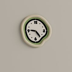 a clock on the wall with green and white trim