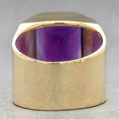 This vintage-inspired Estate 18K Y Gold Amethyst Cocktail Ring puts a modern spin on old-world charm. Featuring a mesmerizing 9.55ct emerald cut amethyst, set in a warm 18k yellow gold band of 16.18mm at the top and 9.57mm at the band, it's a stunning piece that can be sized to your finger! Start a new tradition in timeless luxury. One stamped & tested 18KT yellow gold lady's custom wax & cast gemstone fashion ring with a flat shank with rounded edges with a bright polish finish. The custom made Art Deco Amethyst Ring In Yellow Gold, Yellow Gold Amethyst Ring In Art Deco Style, Art Deco Yellow Gold Amethyst Ring, Art Deco Yellow Gold Amethyst Ring For Formal Occasions, Formal Yellow Gold Amethyst Ring With Bezel Setting, Classic Purple Gemstone Signet Ring, Art Deco Purple Amethyst Ring For Formal Occasions, Formal Purple Amethyst Ring With Bezel Setting, Purple Elegant Signet Ring For Formal Occasions