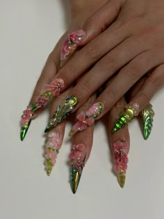 Nails created by (IG: @ninameulders)  The idea behind the nails (IG: @marianaazoch) For the base we use a nude glitter with an ombre of green chromes/ on the other nails a design woth bloominggel. And to top it off a bunch of hand sculpted 3d flowers and other 3d designs🫧🌸 Fake Nails Designs Acrylics Ideas, Long 3d Nails, Green Pink Ombre Nails, Nail Clear Design, 3d Gem Nails, Greek Acrylic Nails, Nail Designs Pink And Green, Artsy Nail Ideas, Sculpted Nail Art