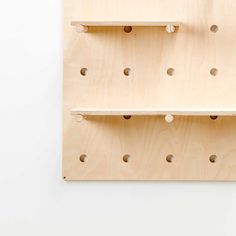 two wooden shelves with holes on them