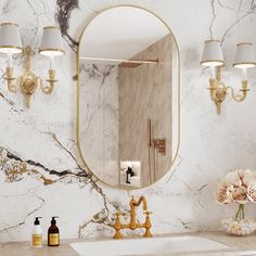 a bathroom with marble walls and gold fixtures