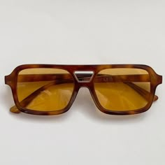 This vintage-inspired aviator is made from brown tort shell acetate and paired with a tan / orange coloured lens. This style is unisex. Dimensions:  Temple length: 14.5cm Lens width: 5.3cm Height: 4.1cm High Quality with UV protection.  Sunglasses are carefully packaged in bubble wrap to ensure they arrive to you in perfect condition 99p UK Shipping We ship using Royal Mail 2nd class and dispatch the same working day if ordered before 2pm. There is also an option at checkout to upgrade your ship Brown Lens Sunglasses, Sunglasses Orange Lens, Brown Square Frame Aviator Sunglasses With Uva Protection, Retro Aviator Sunglasses With Tinted Square Frame, Retro Aviator Sunglasses With Tinted Square Lenses, Brown Aviator Sunglasses With Anti-reflective Square Frame, Retro Square Frame Aviator Sunglasses With Tinted Lenses, Retro Square Frame Aviator Sunglasses With Mirrored Lenses, Brown Square Frame Aviator Sunglasses With Anti-reflective Coating