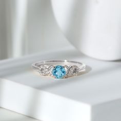 Product Details Indulge in the ultimate sparkle and beauty with our Criss Cross Engagement Ring, adorned with exquisite Round Shape Aquamarine and Diamond stones. The 5 MM Aquamarine Solitaire Ring is the perfect accessory to add a touch of elegance and sophistication to any womans wardrobe. With its stunning design and expert craftsmanship, this ring is sure to catch the eye and be a cherished addition to any jewelry collection. Dont miss out on the opportunity to be dazzled by this radiant and Luxury Topaz Ring With Diamond Accents For Promise, White Gold Cubic Zirconia Topaz Ring, White Gold Topaz Ring With Cubic Zirconia, Luxury White Gold Topaz Ring With Cubic Zirconia, Luxury White Gold Topaz Ring With Accent Stones, Luxury White Gold Topaz Ring With Round Cut, Platinum Topaz Gemstone Ring For Wedding, White Gold Topaz Ring Fine Jewelry, White Gold Topaz Ring With Diamond Accent Stones