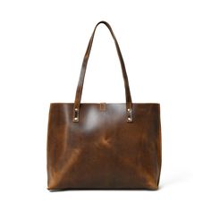 Step out in style with our handcrafted Buffalo Terry Tote. Made from luxurious Buffalo leather, this plain tote boasts a modern look and finish, perfect for your daily needs. Elevate any outfit with this sophisticated and exclusive accessory. Coffee Brown color Handcrafted & made of buffalo leather Top Handle and inside pocket Lightweight & durable leather Size in Inch 15W x 11H x 4 D Inch Size in Cm 38.1W x 27.94H x 10.16D Cm Cool Messenger Bags, Plain Tote, Coffee Brown Color, Best Travel Bags, Motorcycle Saddlebags, Waxed Canvas Bag, Duffel Bag Backpack, Trolley Bags, Best Wallet